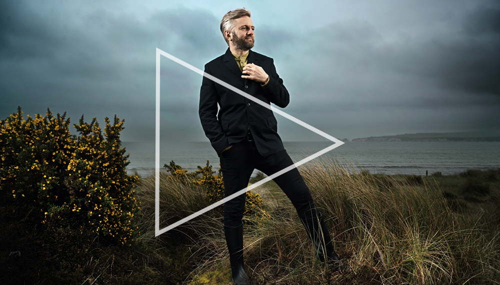 Conductor Kirill Karabits standing in front of a field