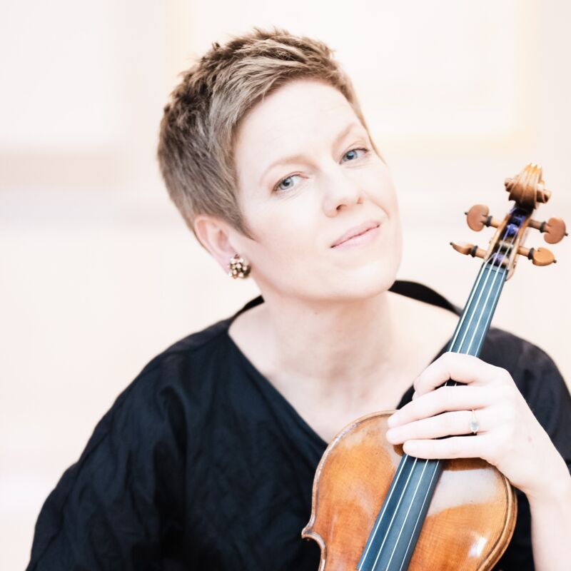 Isabelle Faust holding a violin