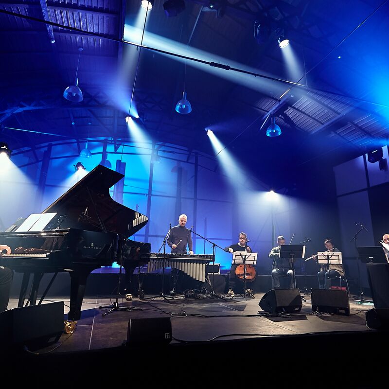 Apartment House performing under blue lights