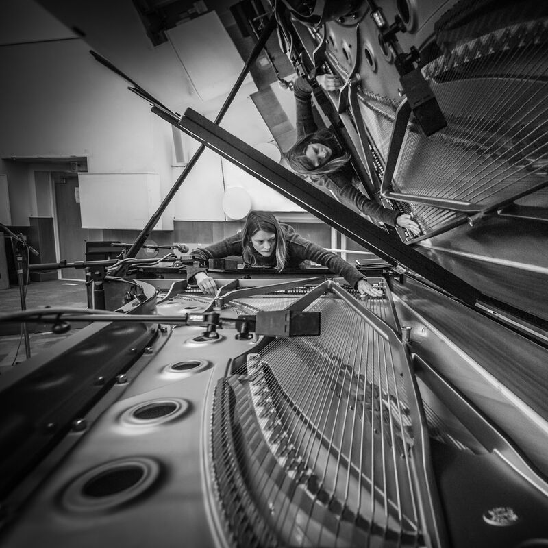 Siwan Rhys looking at the inside of a piano