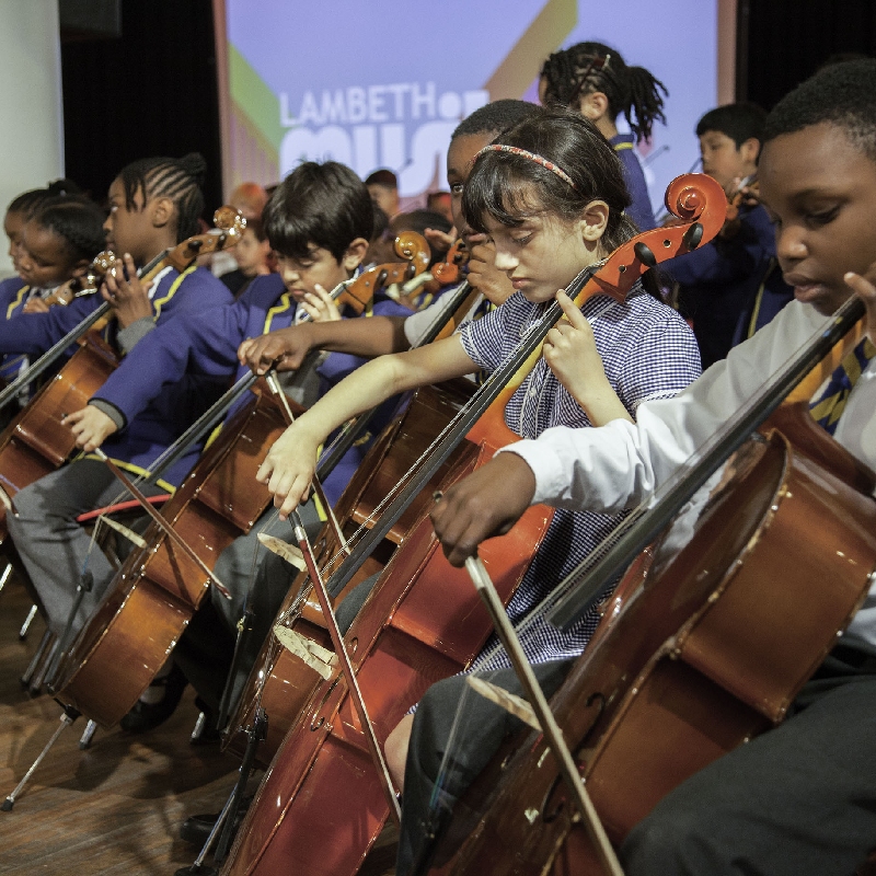 A group of children playing cellos