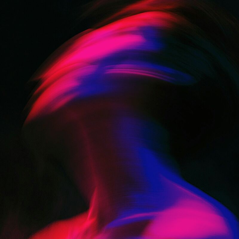 A pink, red and blue blur of a head moving.