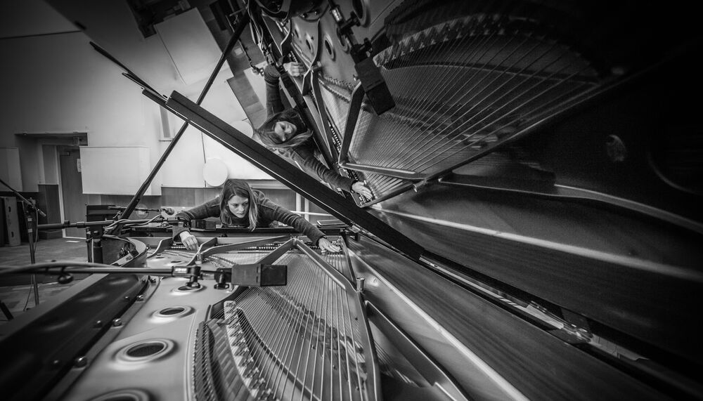 Siwan Rhys looking at the inside of a piano