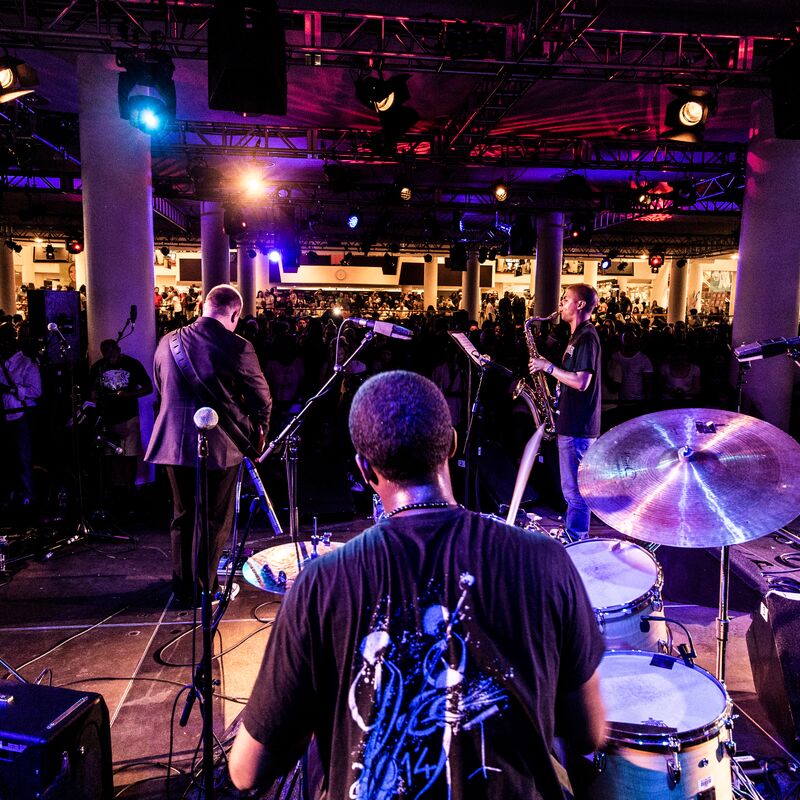 Band members playing various instruments facing away from camera