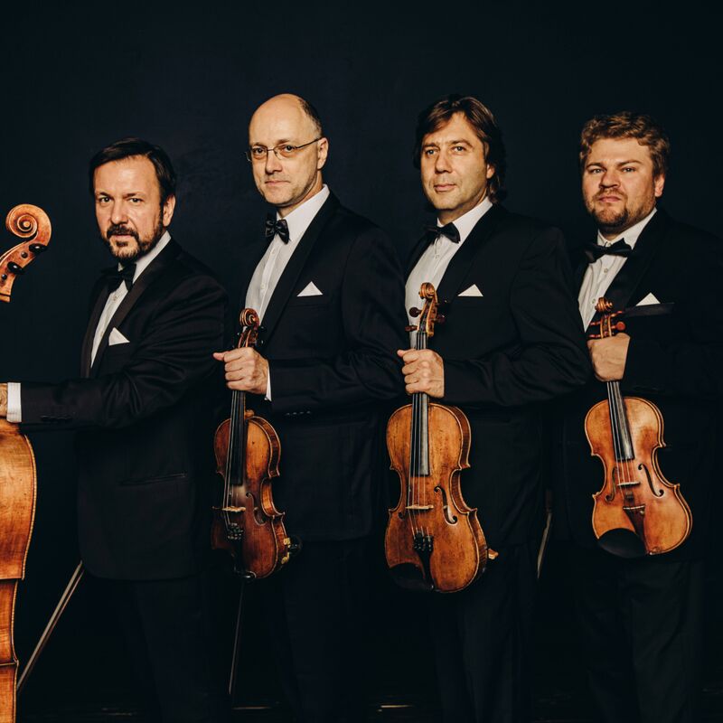 Borodin Quartet standing in a line holding their string instruments