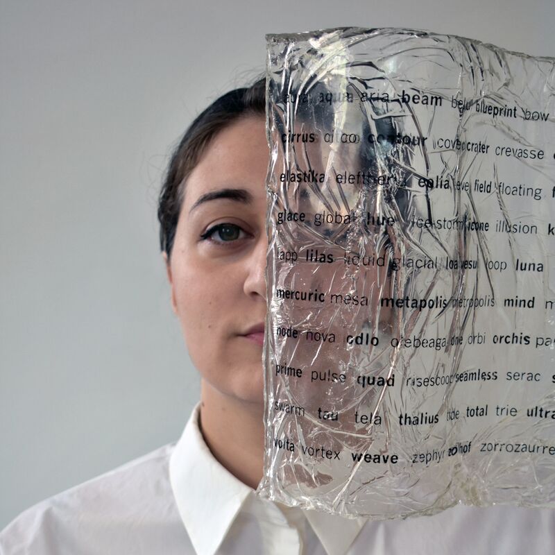 Artist's face behind a transparent page with black letters