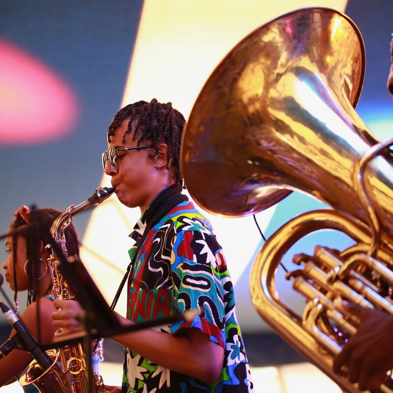 Three young jazz musicians playing the tuba, saxophone and singing as part of Tomorrow's Warriors