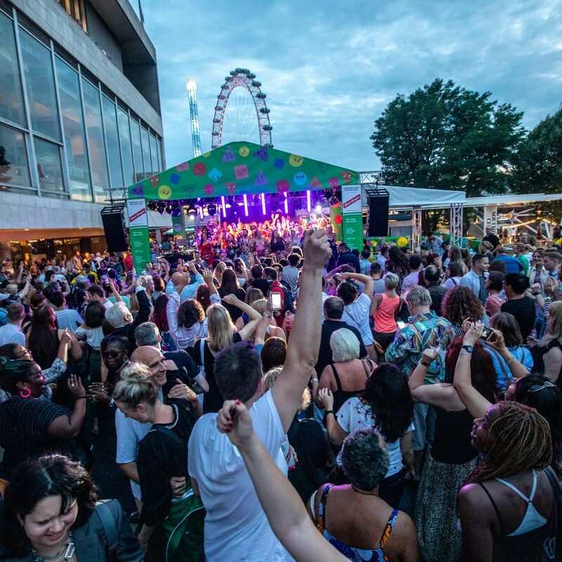 People enjoying the outdoor stage on the Riverside Terrace, Southbank Centre