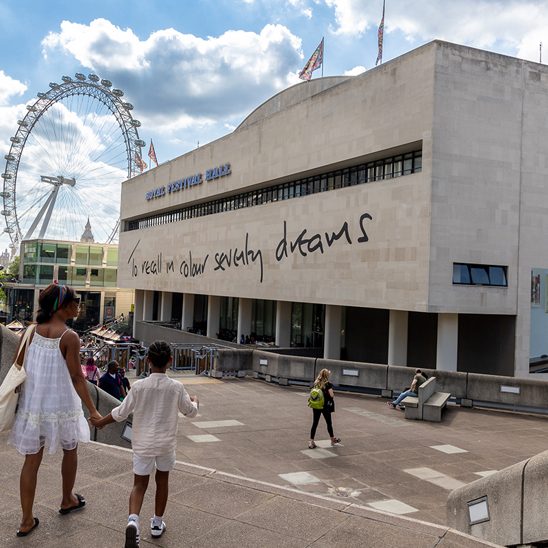 A collection of images showing the free public artwork including an image of steps featuring colourful patterns with people walking up, an image of plant sculptures in the roof garden and a large inflatable head sculpture on a roof.