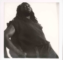 A polaroid of musician Saint Joshua as he leans against a white wall