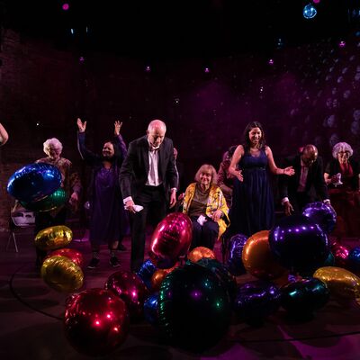 Performers and balloons on stage