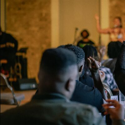 An audience member raises their hand