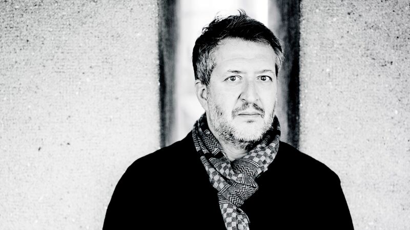 Composer Thomas Ades in a black jacket and scarf