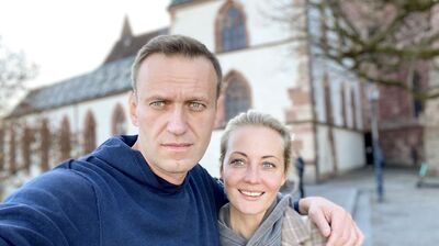 Yulia (right) and Alexei (left) Navalny stand with their arms round each other