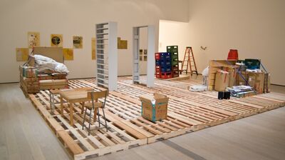 Installation view of Haegue Yang Storage Piece with wooden pallets, and furniture in a large room