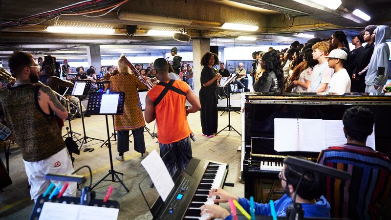 A group of musicians performing in a multi-storey car park