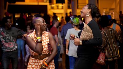 Two women laughing with each other whilst dancing