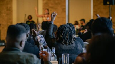 An audience member raises their hand