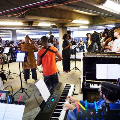 A group of musicians performing in a multi-storey car park