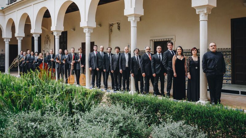 Concerto Italiano ensemble standing in line next to a white building with Islamic architectural features