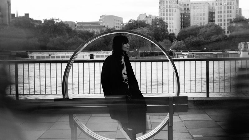 Alice Sara Ott stood against a red Jeppe Hein bench at the Southbank Centre