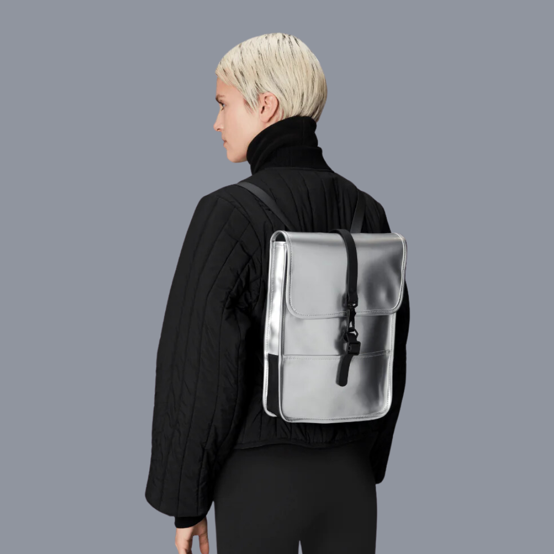 someone wearing the silver rains backpack