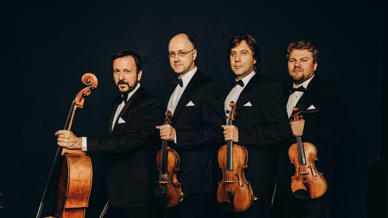 Borodin Quartet standing in a line holding their string instruments