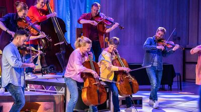 Musicians in colourful clothes playing instruments joyfully