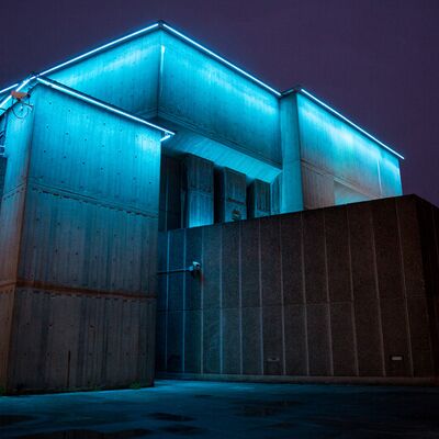 Thin neon lights line the verge between the roof and the wall of the Queen Elizabeth Hall