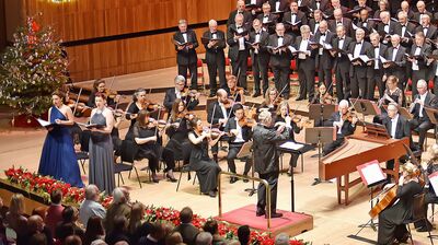 A large ochestra and choir wearing suits and dresses performing Vivaldi's Gloria at Christmas time