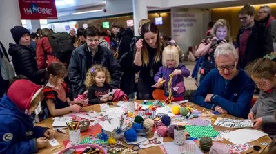 a group of families engaging in some craft activites