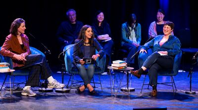 Three panellists speaking on stage sat in arm chairs at a talk at Southbank Centre.