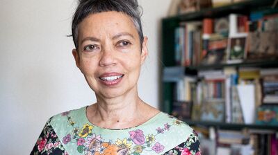 Author Michelle de Kretser wearing a flowery dress with an image of a fox on it.