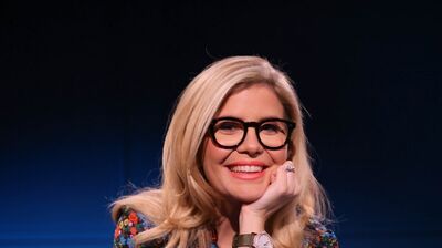 Emma Barnett sitting on a yellow chair with her head resting on her hand.