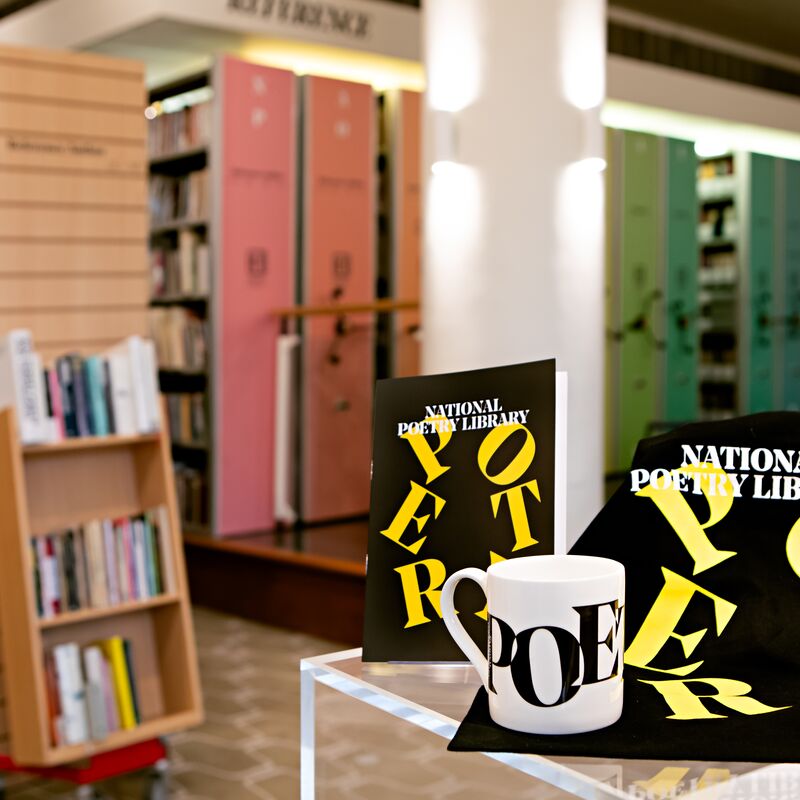 The National Poetry Library - in the foreground, a branded white mug with the word Poetry in black printed on it