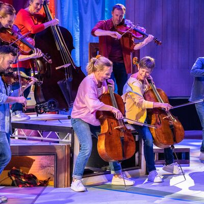 Musicians in colourful clothes playing instruments joyfully