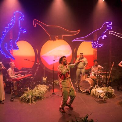 Performers on stage during a production of The Colour of Dinosaurs.