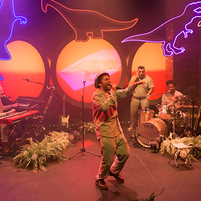 Performers on stage during a production of The Colour of Dinosaurs.