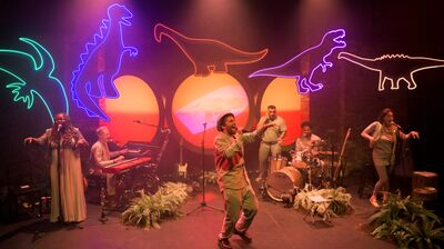 Performers on stage during a production of The Colour of Dinosaurs.