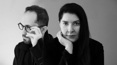 A black and white composite image of Igor Levit looking to the left of frame, wearing spectacles, and Marina Abramović looking directly at the camera