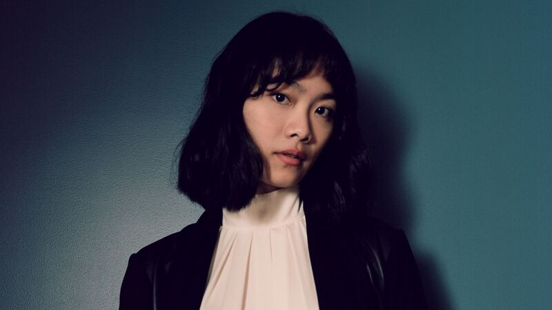 Pianist Tiffany Poon in front of a blue wall