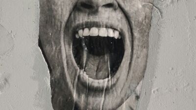 Screaming mouth emerging from light grey wall