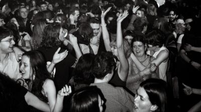 A black and white image of a rambunctious dancefloor, it looks fun.