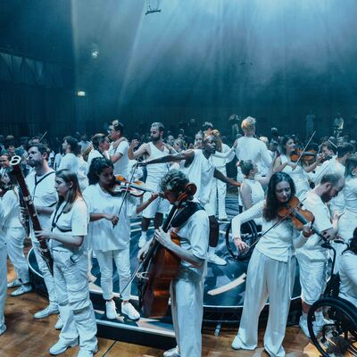 A group of musicians on a raised platform, playing different instruments