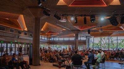 An audience sat in the Queen Elizabeth Hall Foyer watching a performance