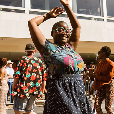 a woman dancing in sunglasses