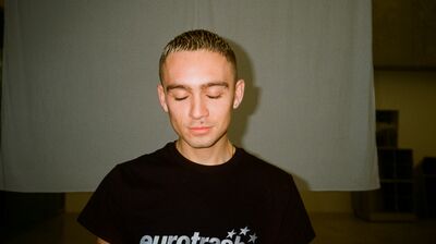 Corbin Shaw wearing a black T Shirt with the word 'eurotrash' on it.