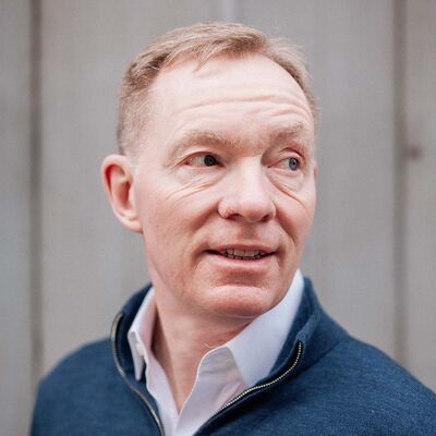 Chris Bryant wearing a blue jumper and shirt.