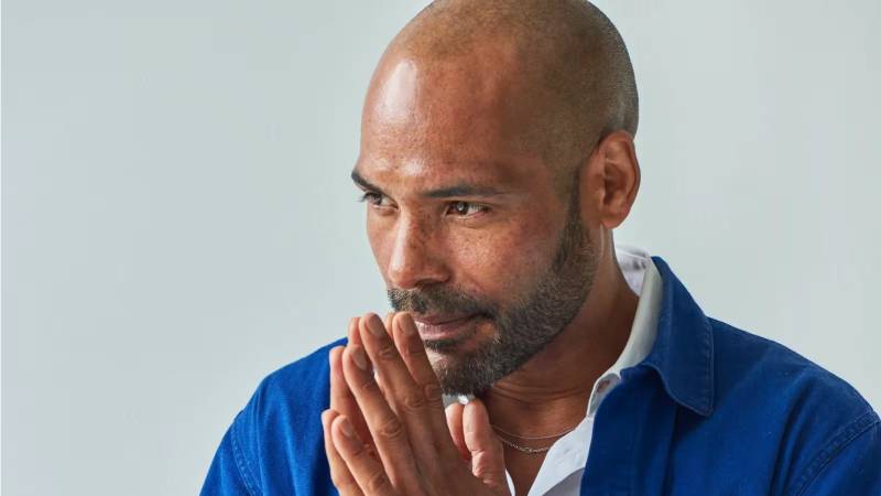 Benoit Swan Pouffer, a bald mand with a slight beard. His hands are held together in front of his mouth.