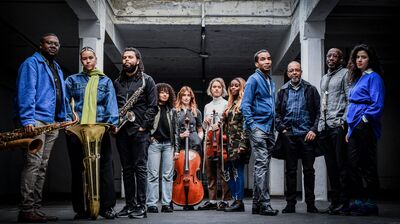 A group of musicians holding string and brass instruments